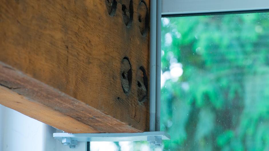 A wooden beam joining with a window